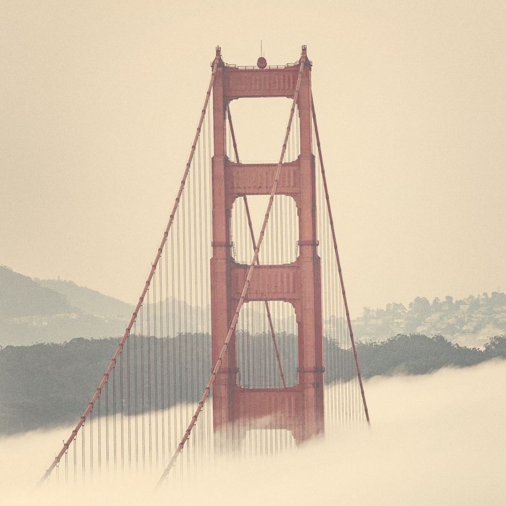 The Golden Gate Bridge half hidden in morning fog