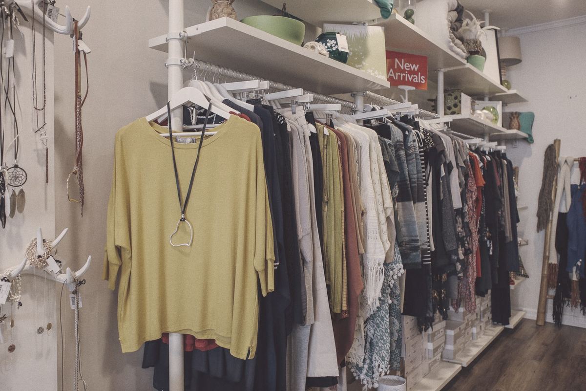 Clothes on rails and shelves in a small boutique
